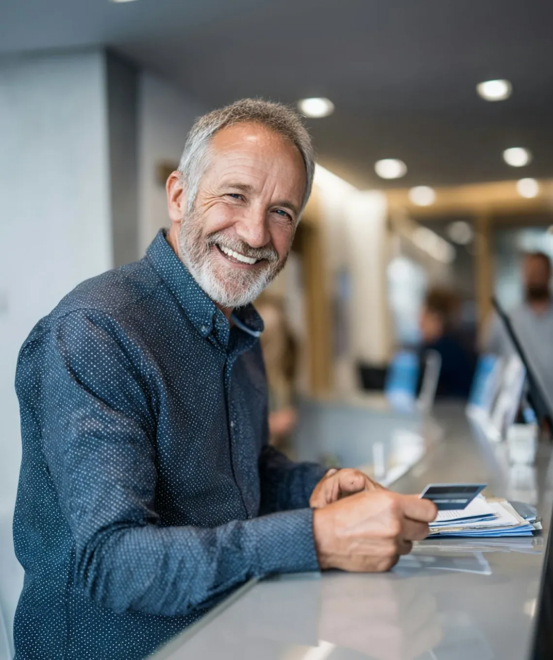 A patient checking in at the front desk at The Smile Center.