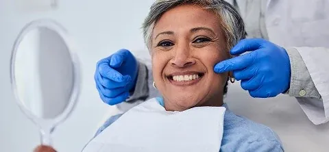 A dentist with a patient in the chair at The Smile Center.