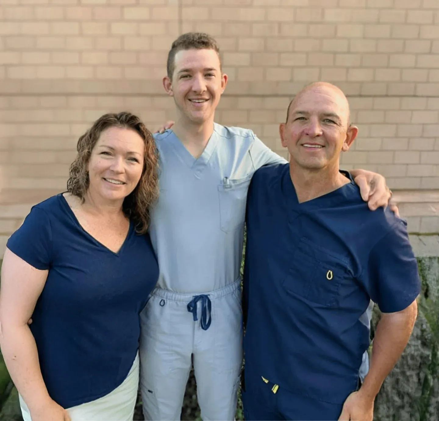 Dr. Tara Frey, Dr. Taylor Parr and Dr. Scott Parr outside The Smile Center.