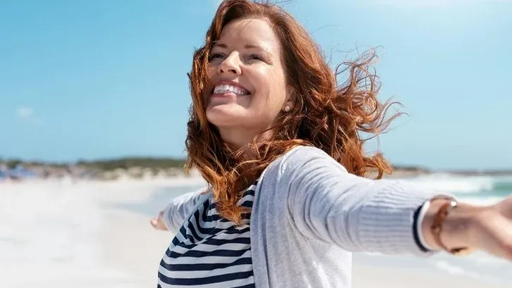 A patient of The Smile Center on the beach in Virginia Beach.